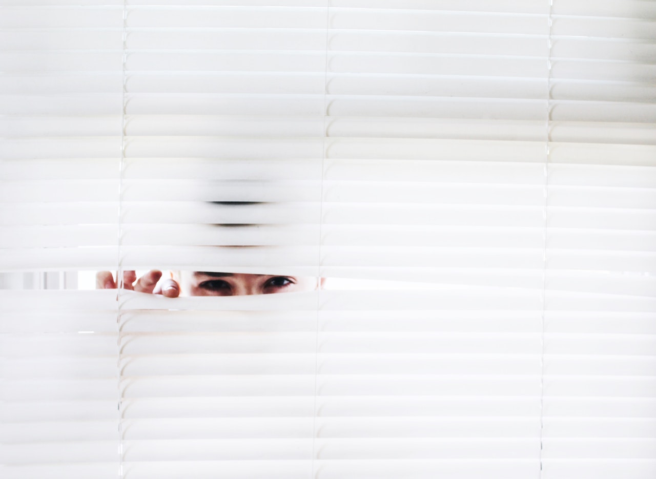 Peepin man in window blinds